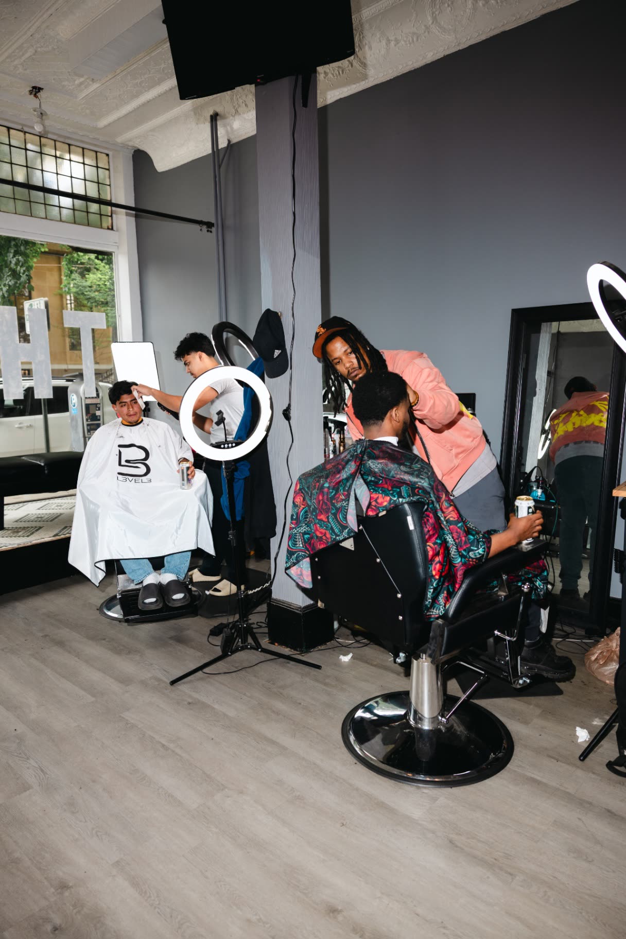 Chairs, mirrors, and daylight inside The Ave Barbershop