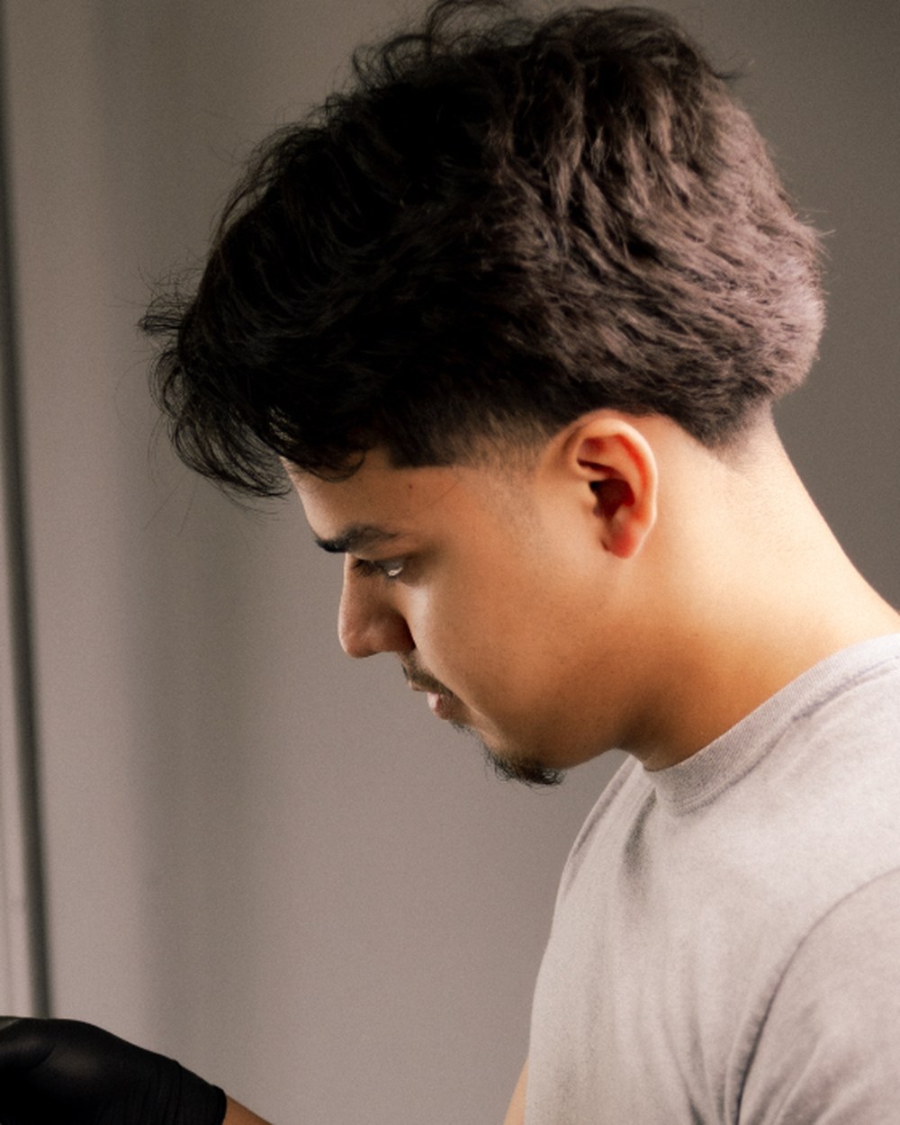 Oscar, barber at The Ave Barbershop